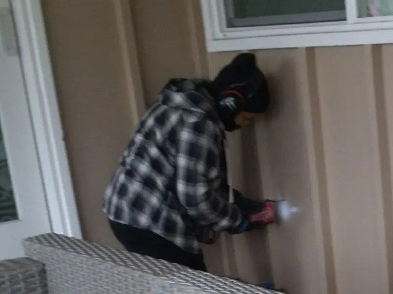Professional electrician installing an exterior outlet in Dumfries